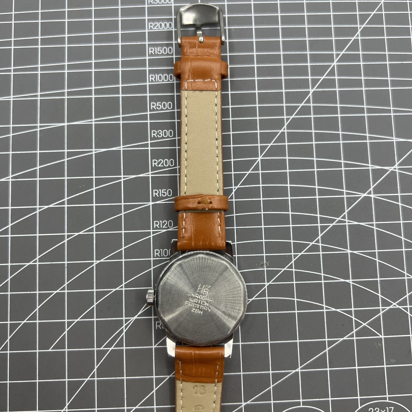 Silver 32mm Shanghai Factory manual mechanical watch with silver case, nail markers, and classic design
