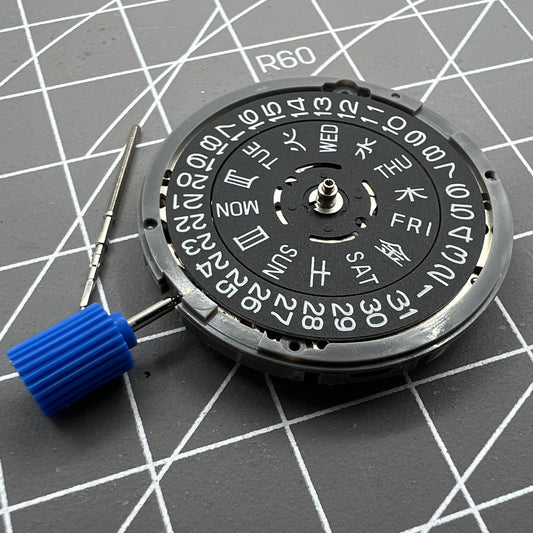 Miyota NH36A black automatic watch movement with green lume and three crown positions for precise timekeeping.