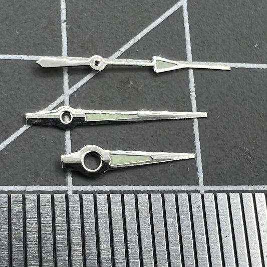 Luminous silver-trimmed watch hands for Miyota 2035 quartz movement, enhancing visibility and style.