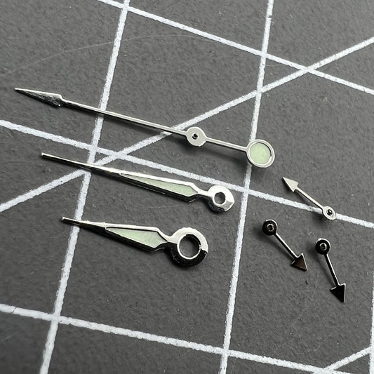 Silver trim green luminous pointed watch hands for Miyota OS series, enhancing readability and style.