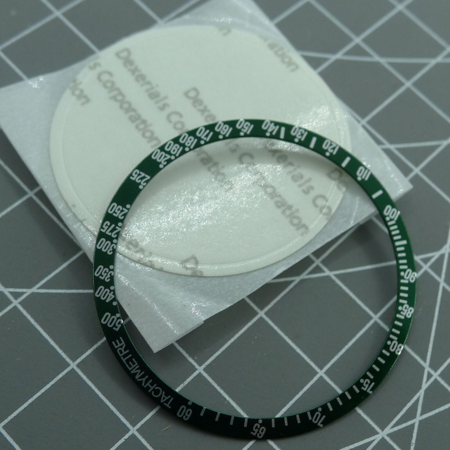 Green 38.5mm aluminum bezel with white font for Omega Speedmaster, precision watch upgrade accessory.