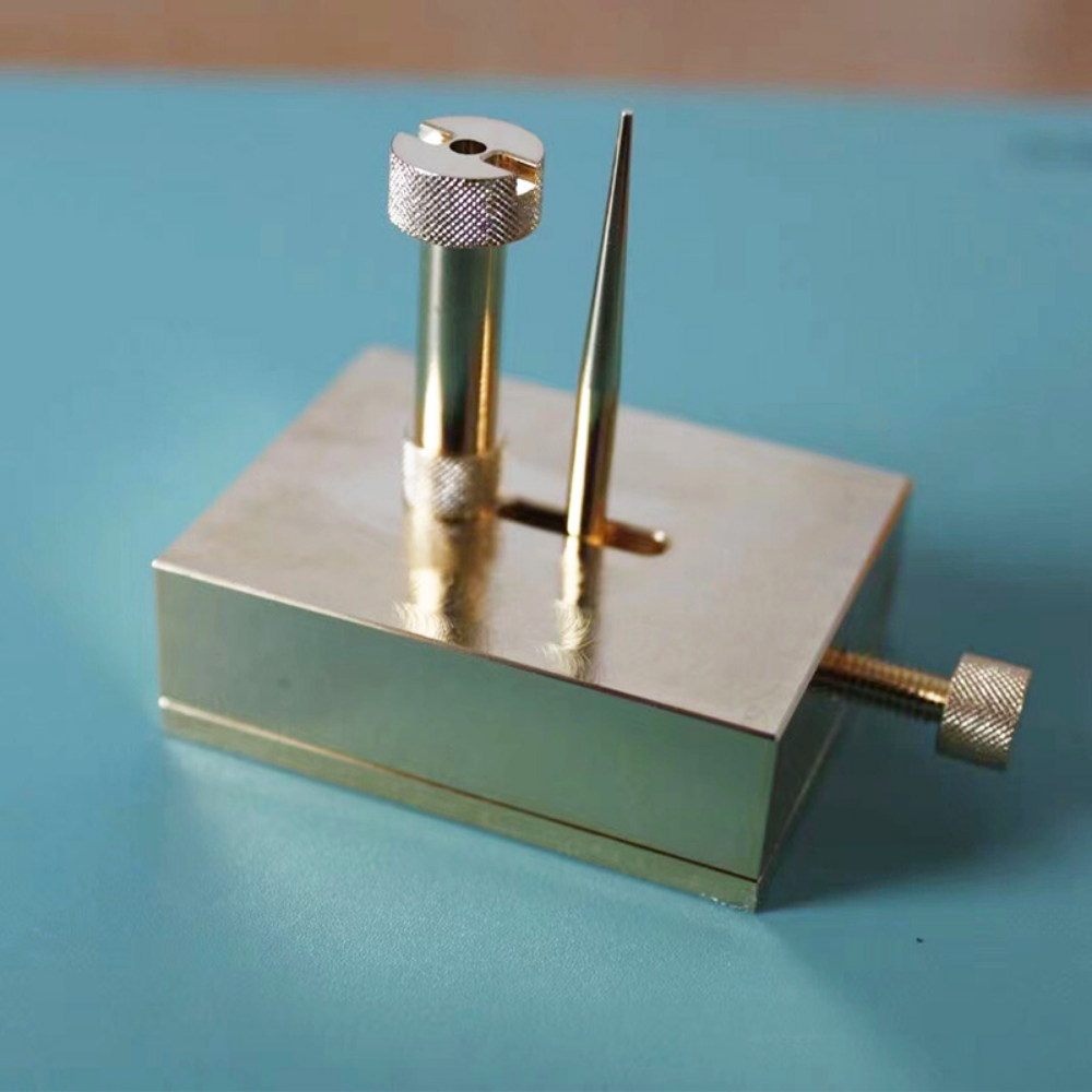 Brass adjustable balance-cock support tool for precise watch repairs with dust cover.