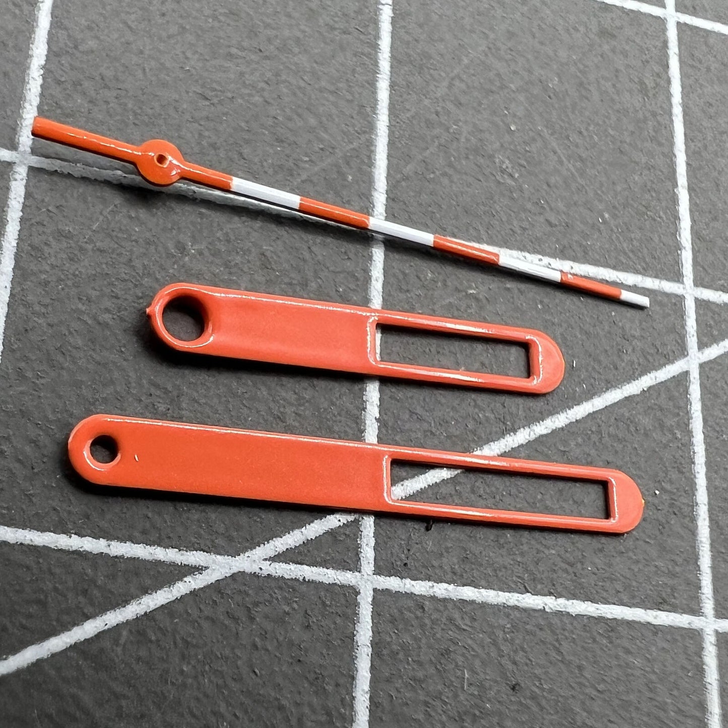 15mm Hollow orange and white trimmed watch hands for Ronda 515 movement, precise and stylish.