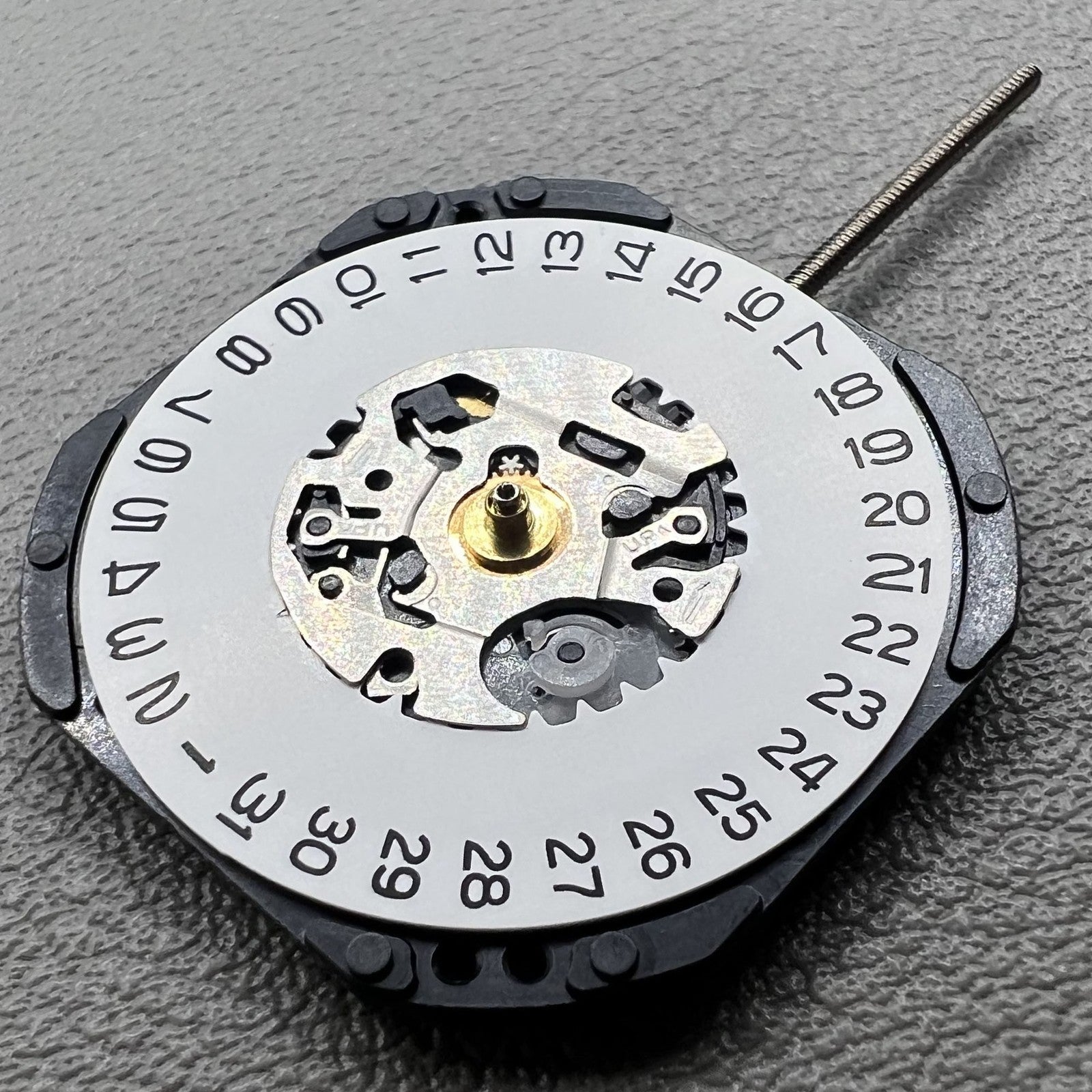 Japan Hattori Epson VX32 quartz watch movement showing date at 3 o'clock, precise timekeeping for watches.