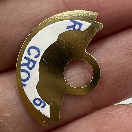 Golden waved metal sheet overlay by Hammer for Miyota 9015 rotor, enhancing watch movement aesthetics.