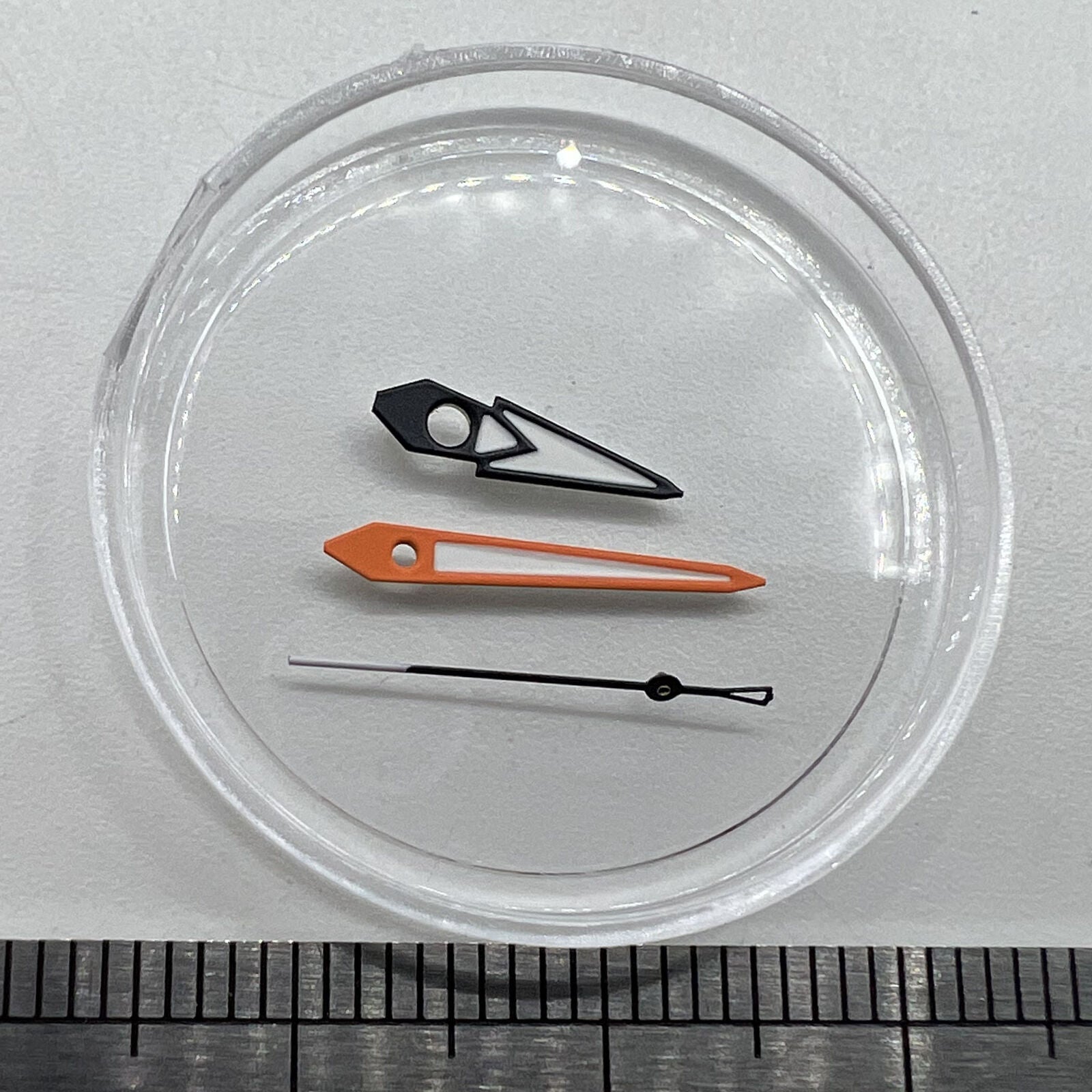 Watch hands with green lume, black and orange trim, white painted, compatible with NH35/36 movements.