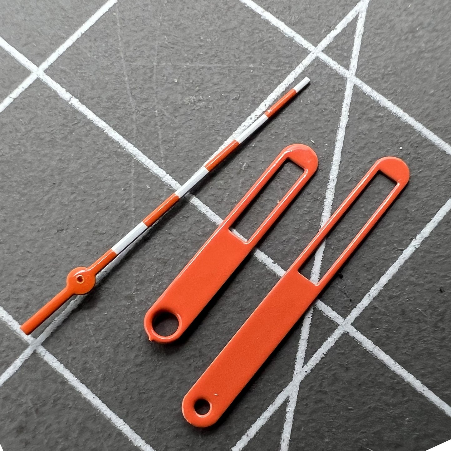 15mm hollow orange and white trimmed watch hands for Ronda 515, precise style.