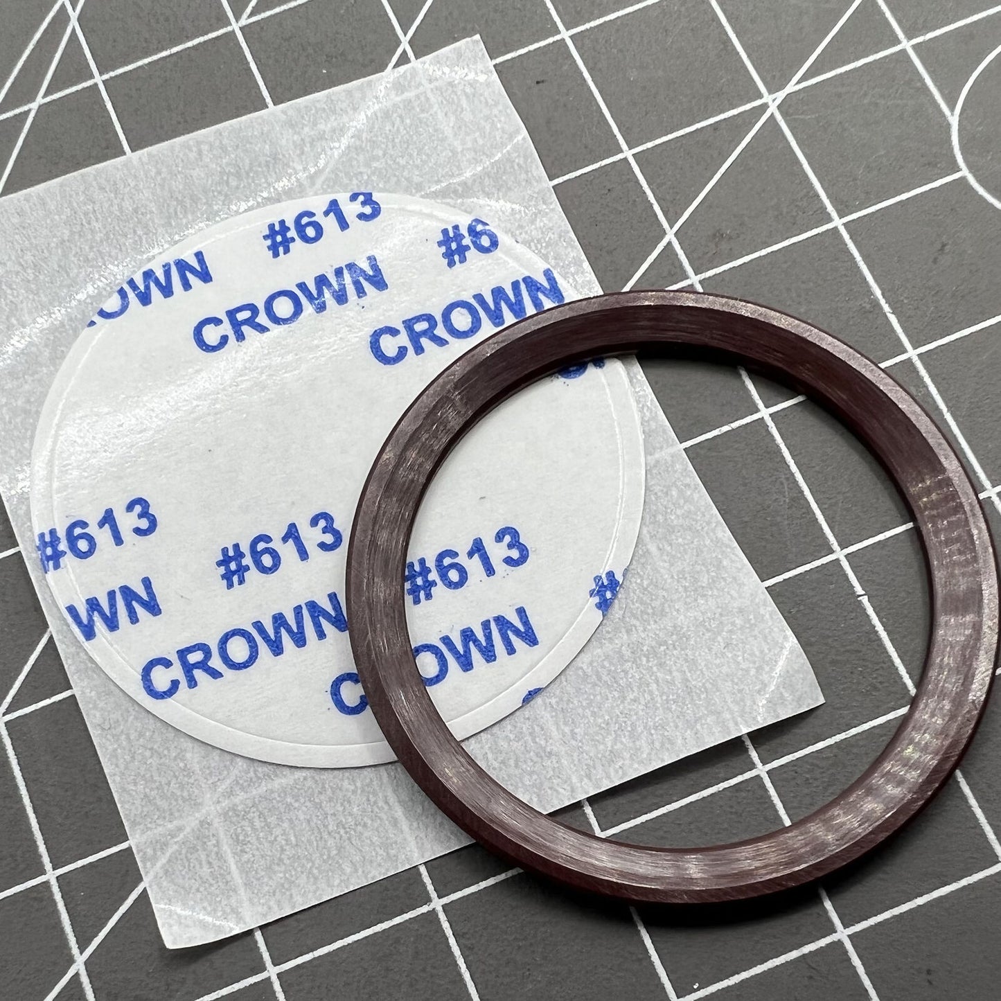 Brown ceramic watch bezel for Daytona, 37.65x30.7mm, with white font, durable luxury accessory.