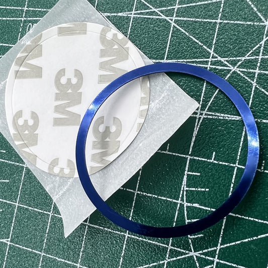 Blue aluminum alloy watch bezel with white font, compatible with Omega Speedmaster - durable accessory.