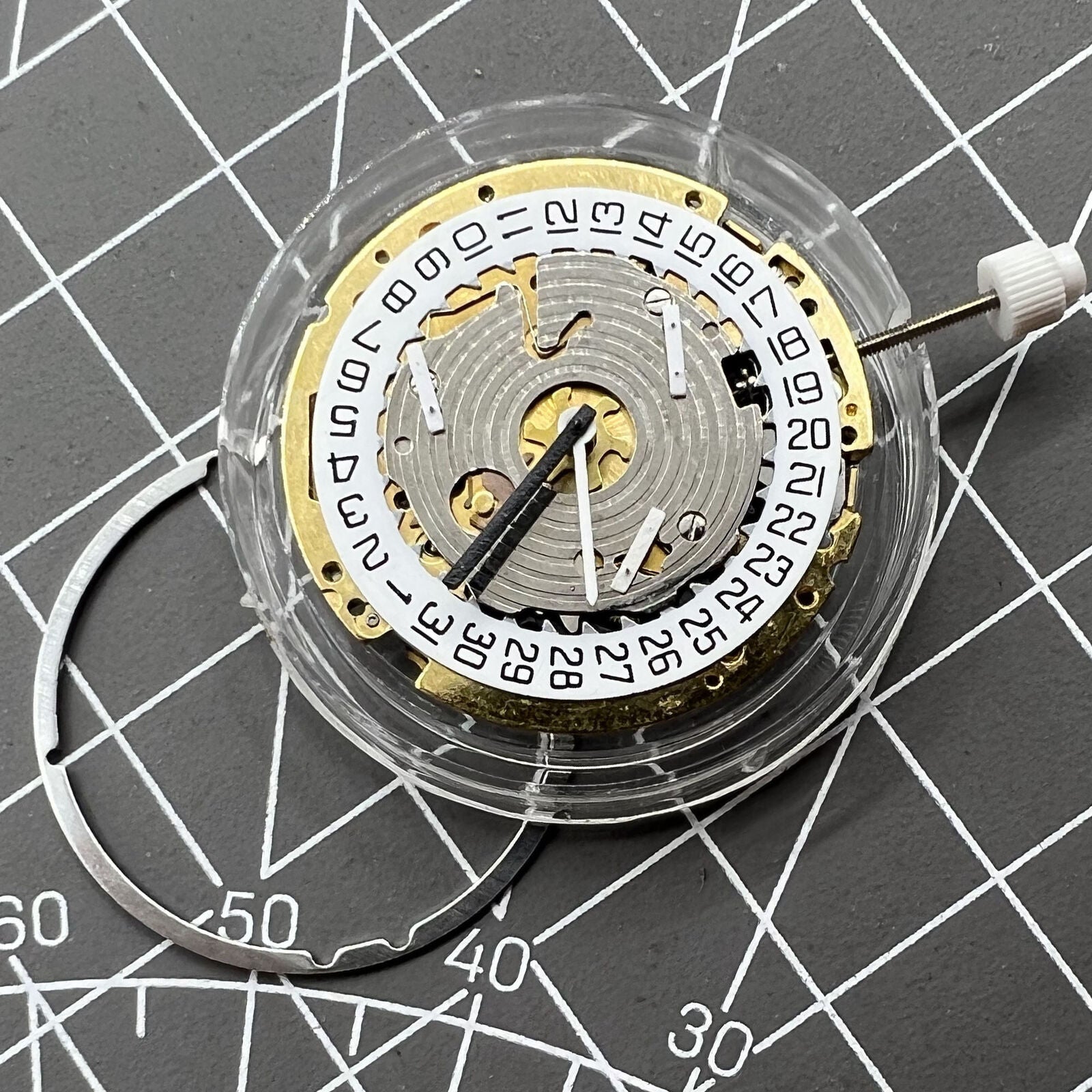 ISA 8171 Swiss made quartz watch movement with date at 4 and 6 hands on white dial.