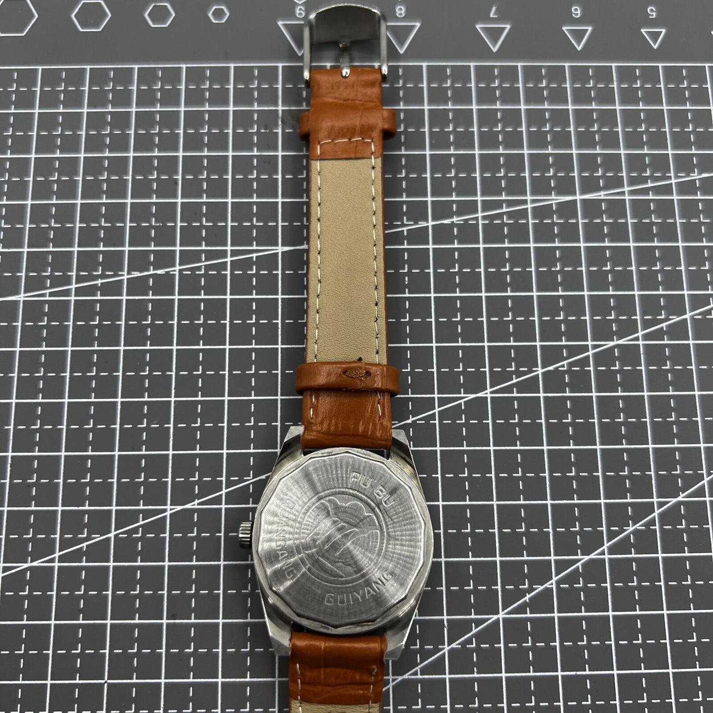PUBU 32mm manual mechanical watch with grey dial, 17 jewels, elegant nail indices showcasing Chinese craftsmanship.