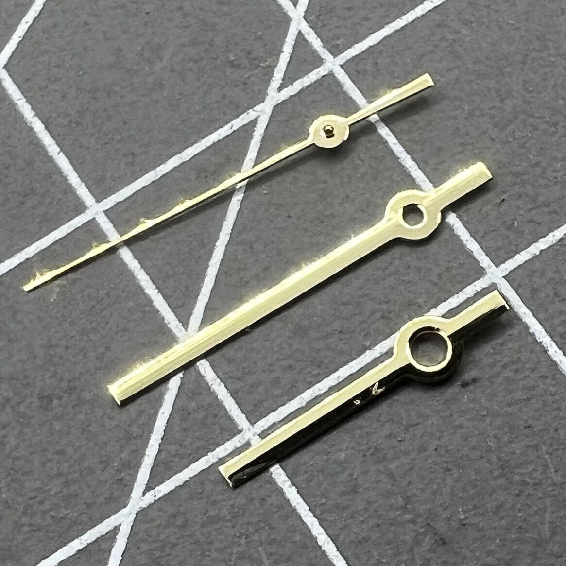 Golden polished 12mm watch hands set, designed for Ronda 515 quartz movement, sleek and precise replacement parts.