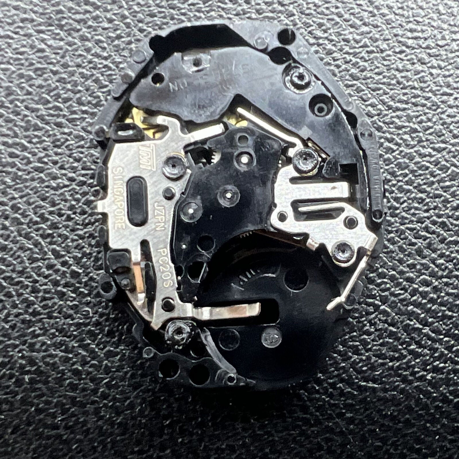 Hattori Epson TMI PC20 quartz watch movement, precision Japan-made mechanism for accurate timekeeping in watch accessories.