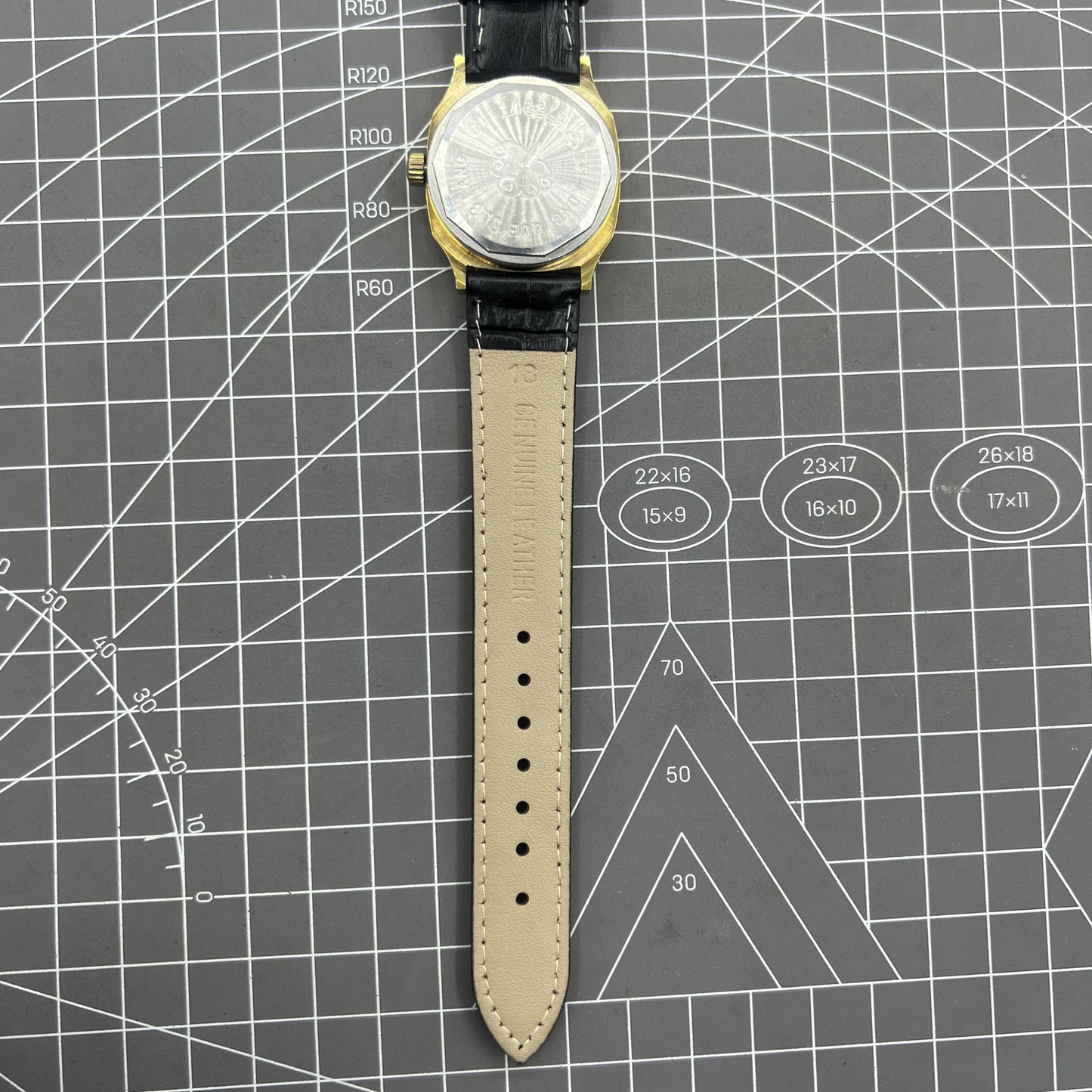 Black Dandong manual mechanical watch with 17 jewels, golden dial, and single calendar for classic elegance.