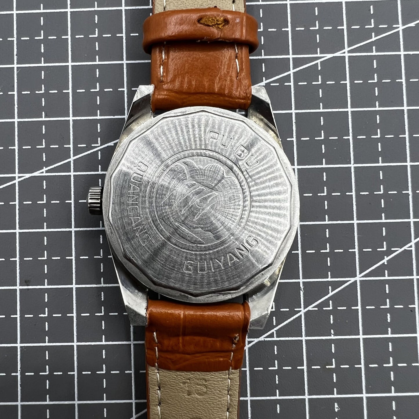 PUBU 32mm manual mechanical watch with grey dial, 17 jewels, elegant nail indices, showcasing Chinese craftsmanship.