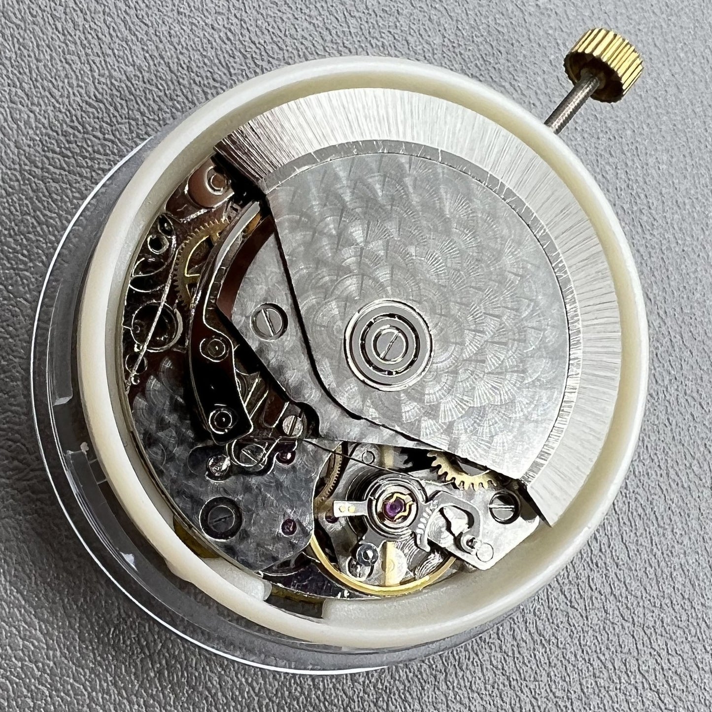Dandong 7750 mechanical watch movement featuring single calendar and small seconds at 6, 9, and 12 o'clock positions for precision timekeeping