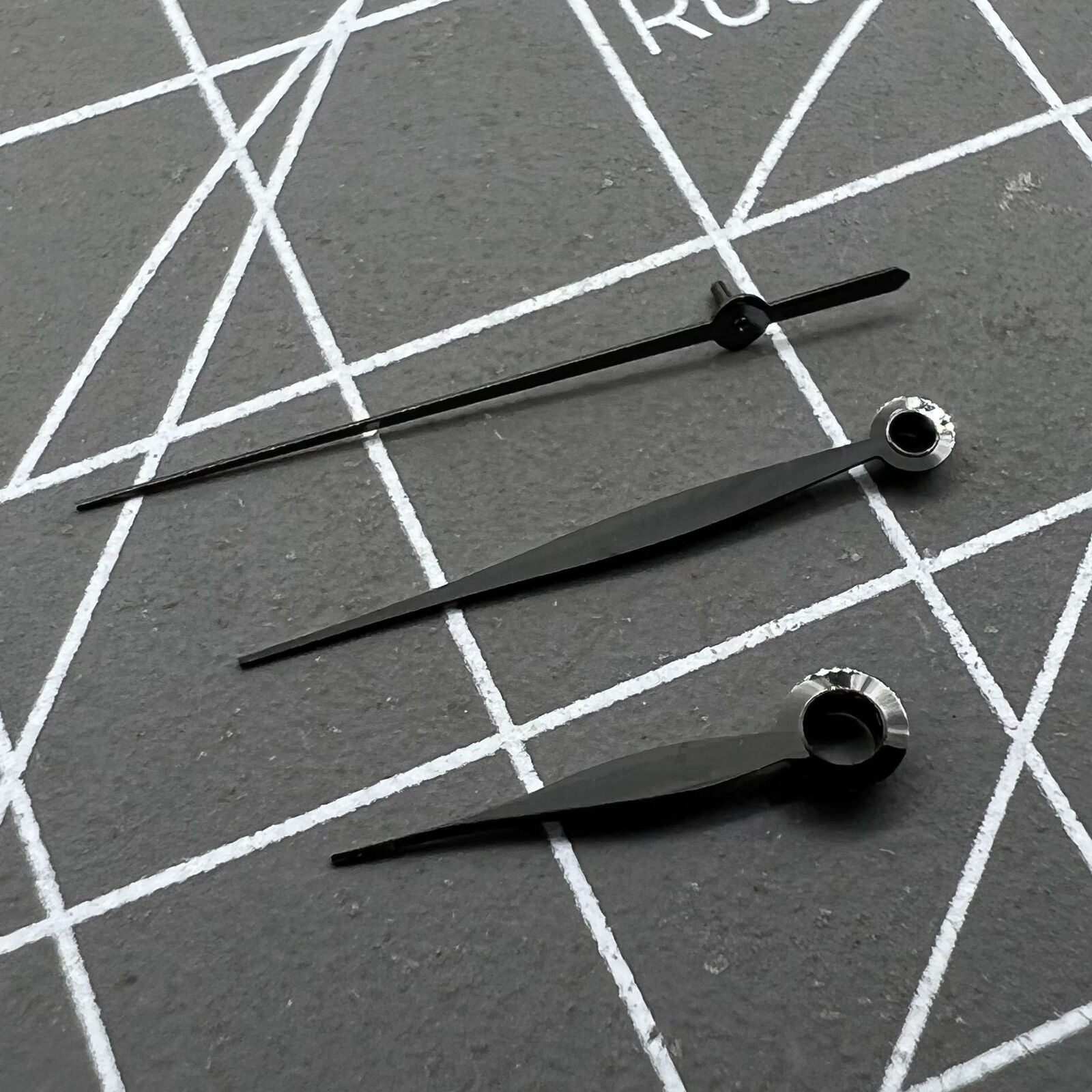 Polished black leaf shape watch hands set for LB06 movement, sleek and precise design.