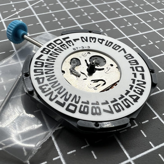 Miyota 6M53 quartz movement displaying big date at 3 o'clock with three hands for precise timekeeping.