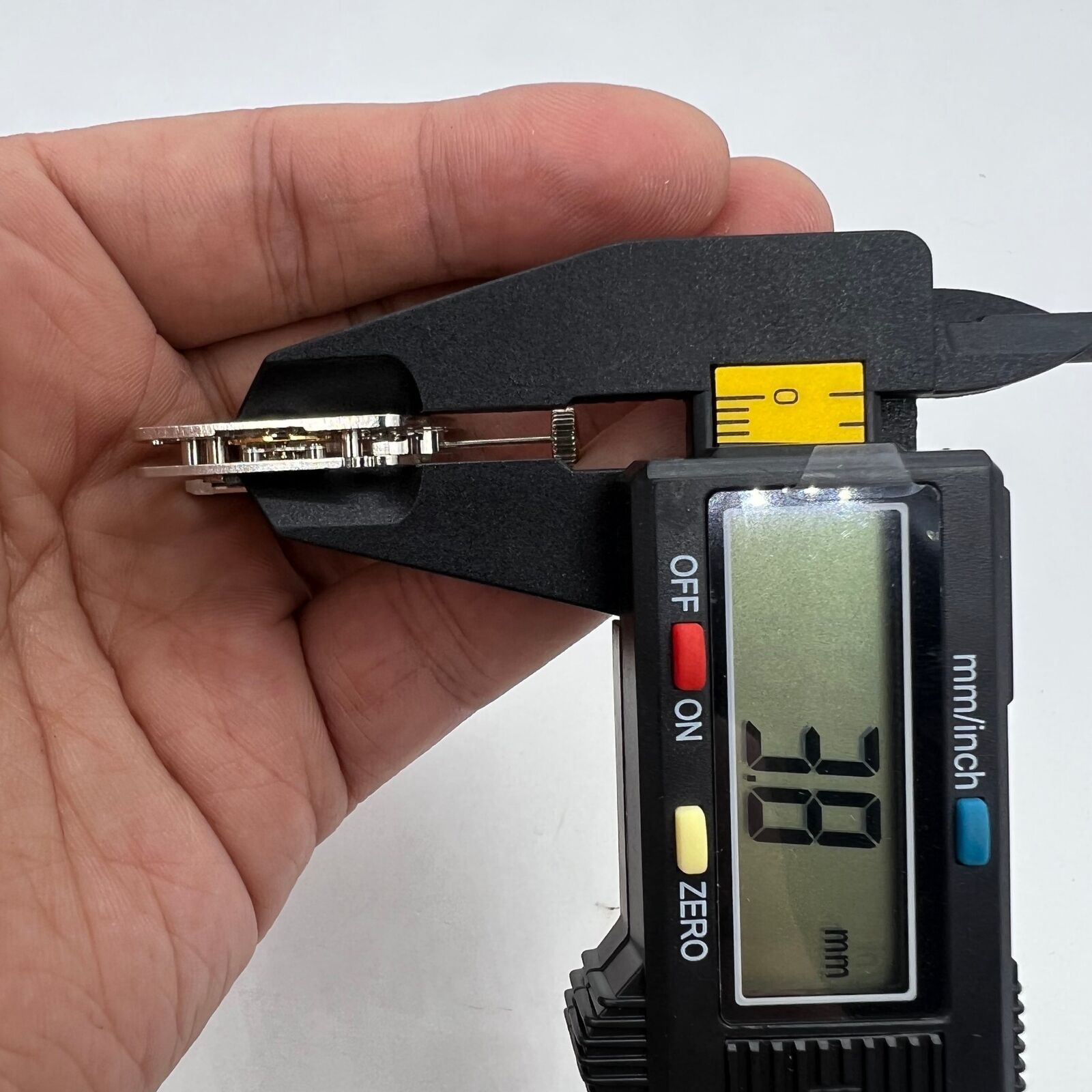 Asian HZ1C01A silver barrel-shaped watch accessory with automatic mechanical movement detail