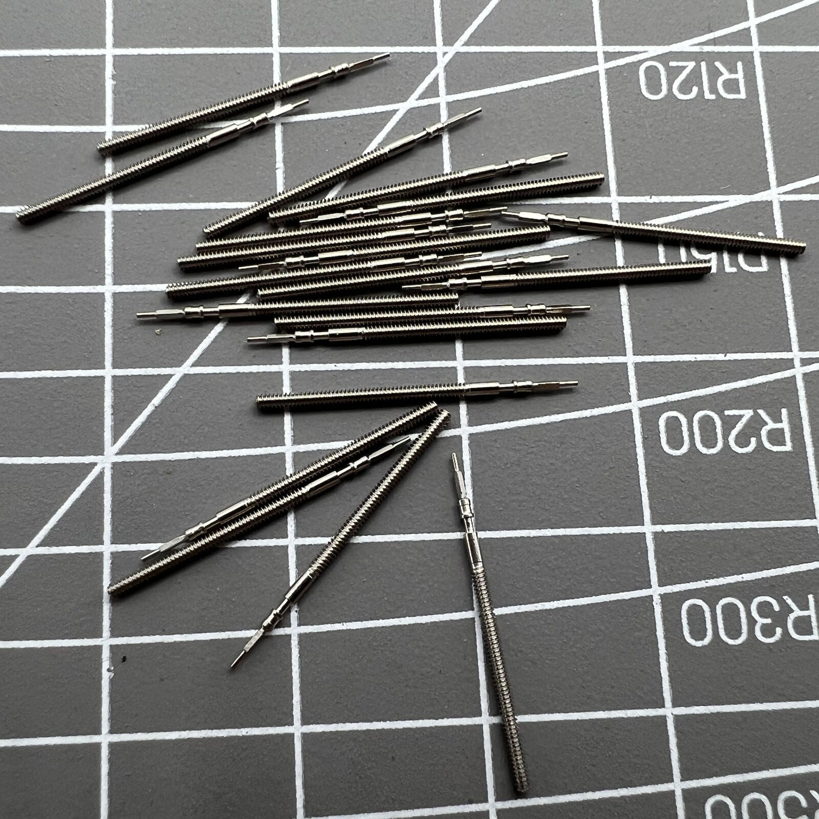Set of 10 generic watch winding stems for 1M02, 1L22, 1M12, 1L02 movements, ideal for watch repair.