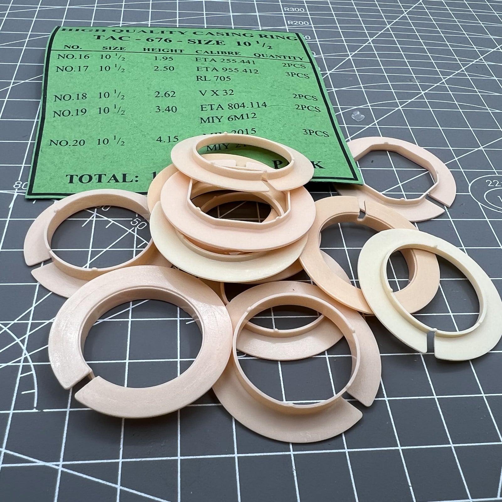 Set of 12 plastic movement holder spacers for ETA 255.441/955.412/804.114 watch casings, precise fit for secure assembly.