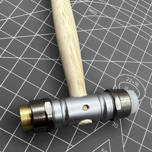 Swiss Bergeon 30417 watchmaker's hammer with replaceable brass and synthetic ends for precise watch repairs.