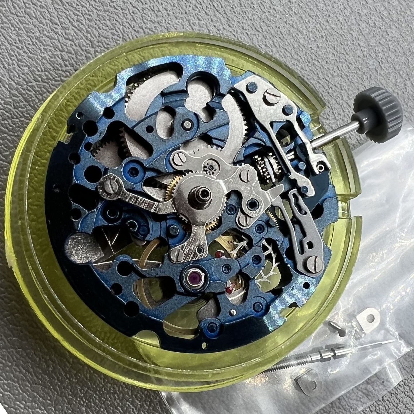 Genuine Miyota 8N24 blue hollow automatic watch movement showcasing precise mechanical timekeeping.
