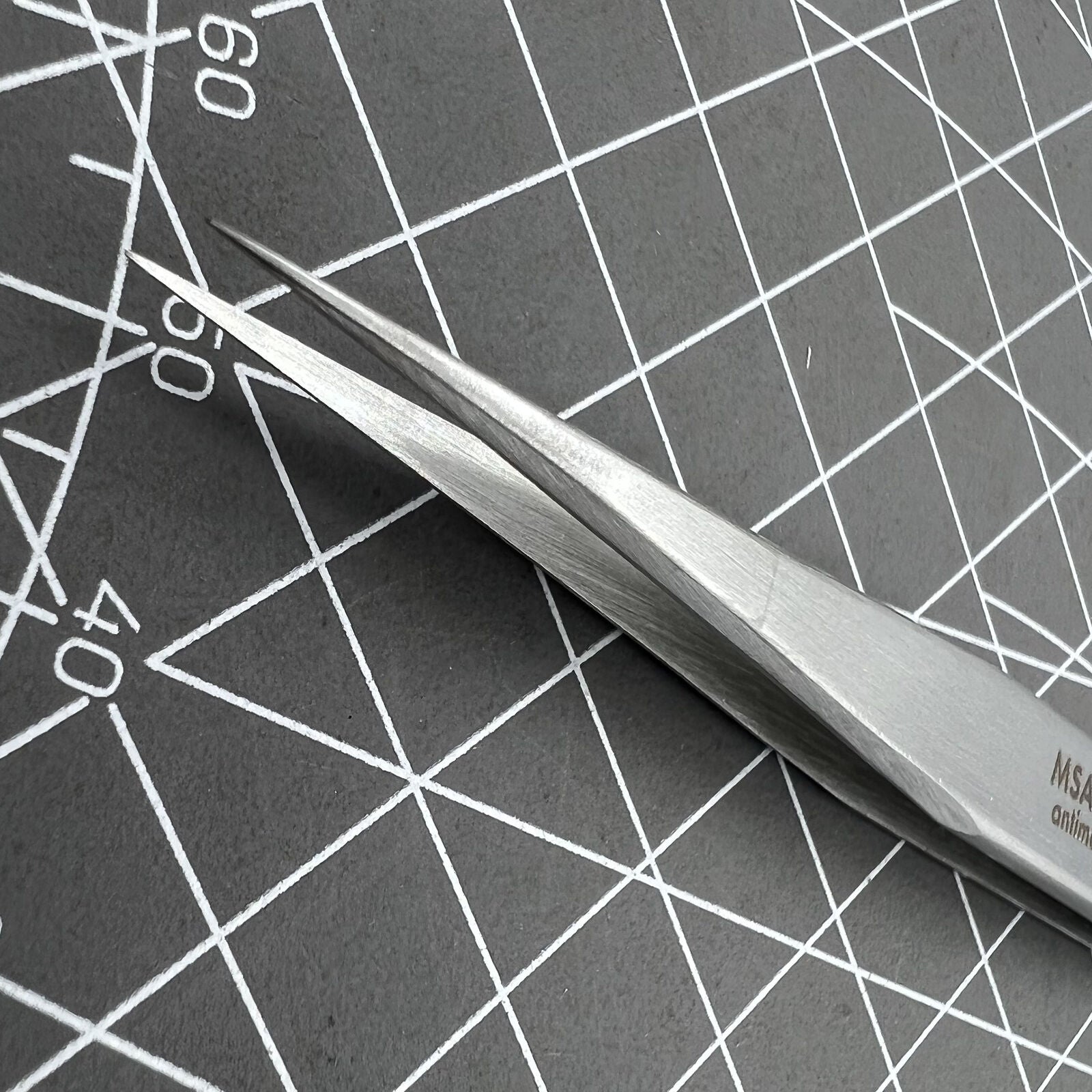 Swiss Horotec antimagnetic fine tweezers for precise hairspring handling in watch repairs.