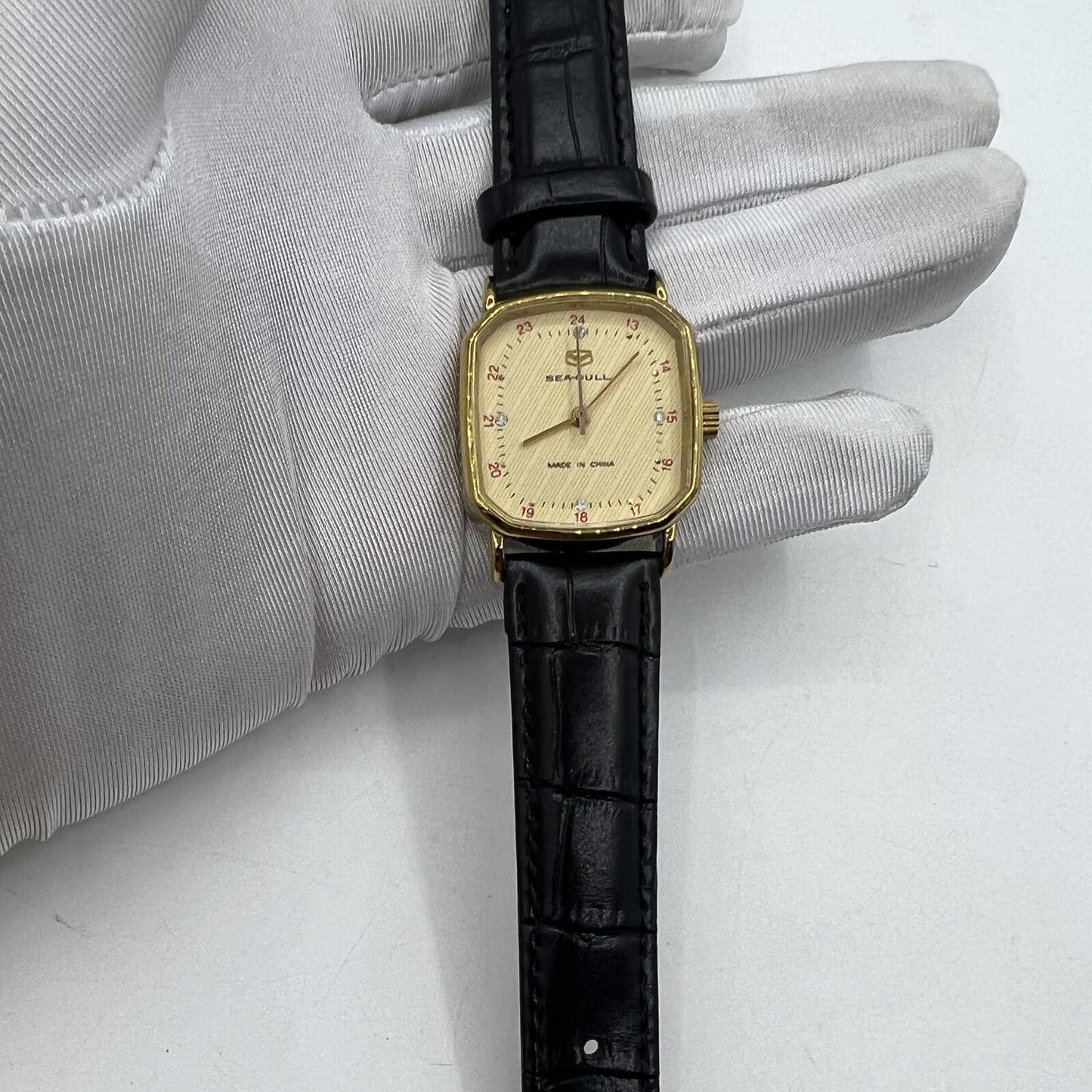 Seagull 28mm ladies watch with golden square case, manual mechanical movement, elegant design for stylish wear.