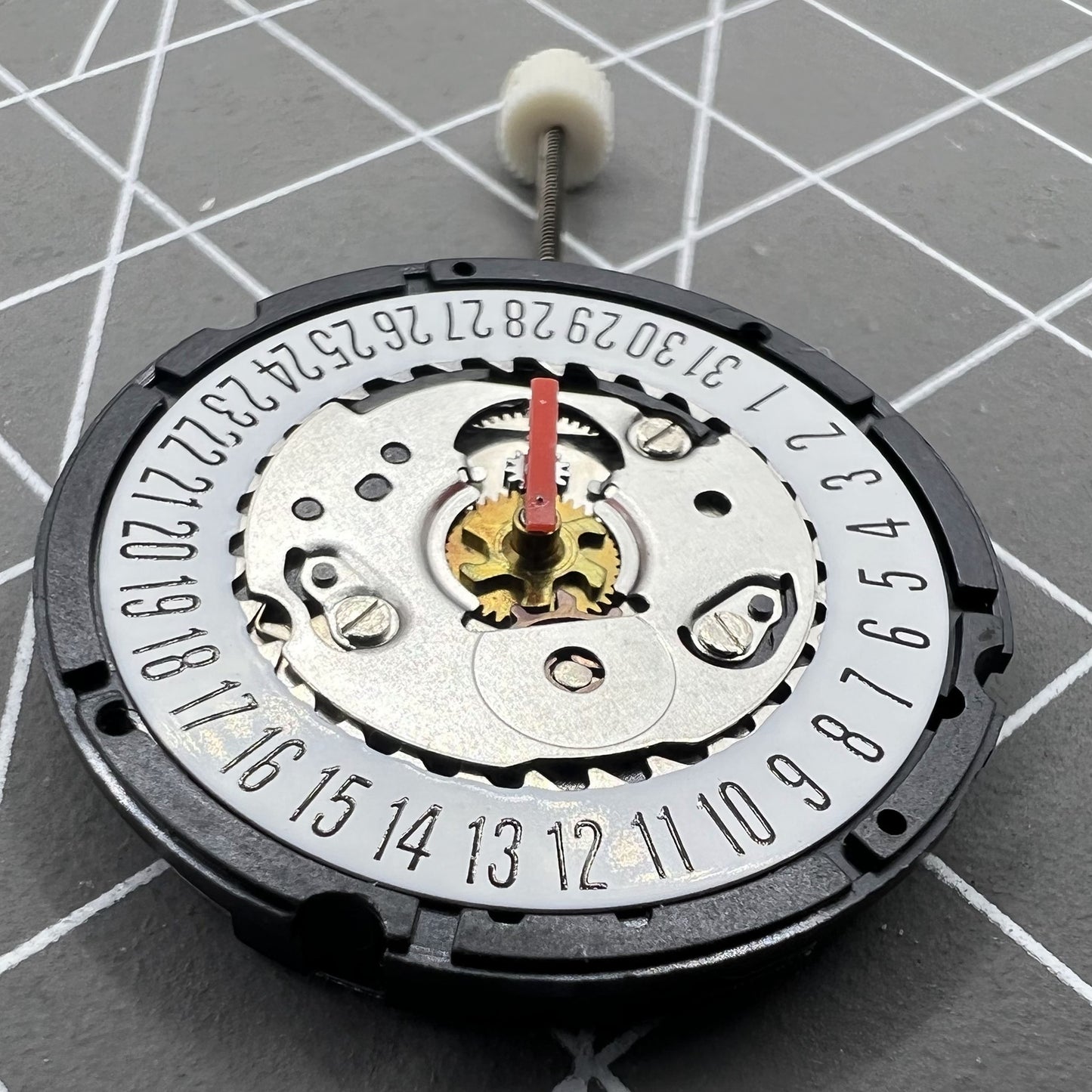 ISA 307 quartz watch movement showing date at 6, brand new old stock for accurate timekeeping.