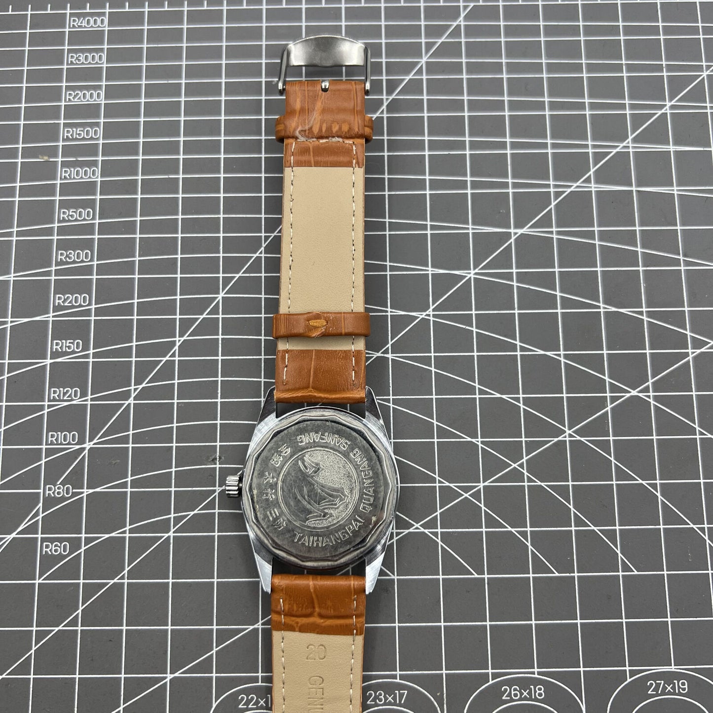 38mm TAIHANG mechanical watch with golden indices, silver dial, round case, and 17-jewel movement for precision timekeeping.