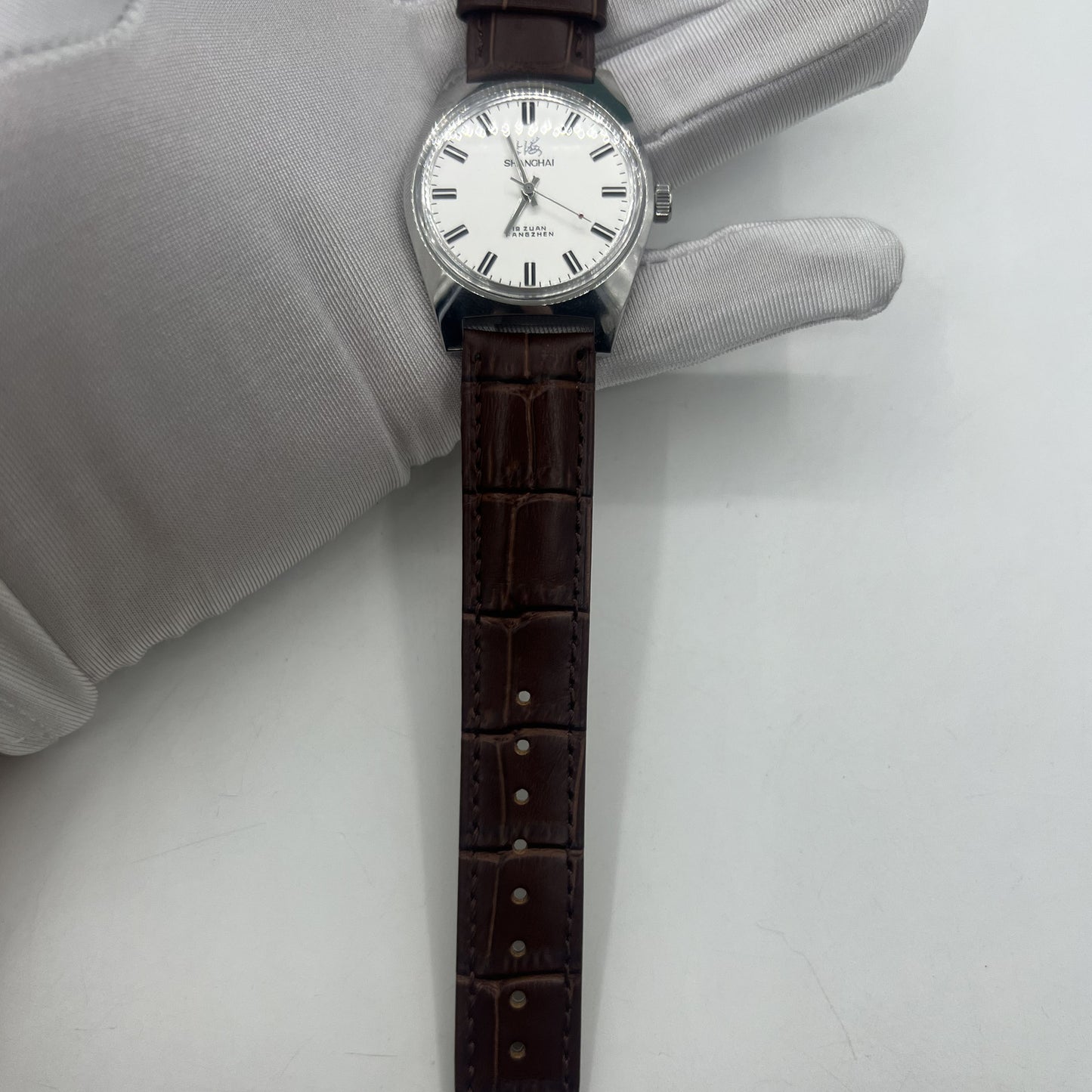 Shanghai Factory 38mm manual watch with white dial, 3 hands, 19 jewels for accurate timekeeping.
