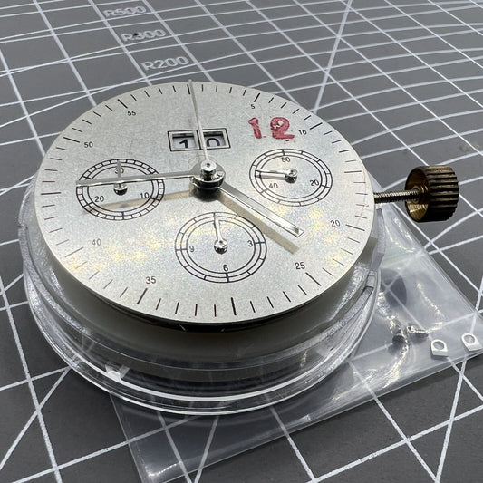 7750 mechanical watch movement showing big date at 12 and small second at 3, detailed close-up