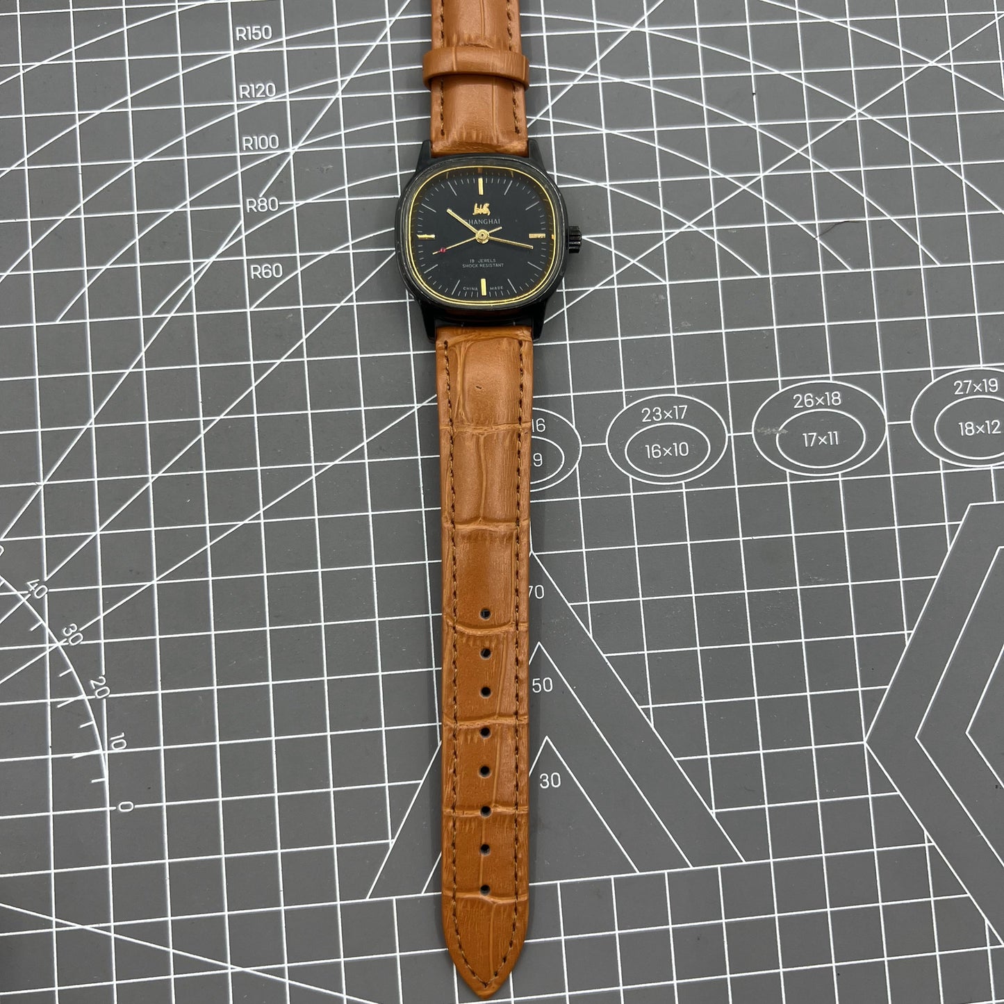 34mm Shanghai Factory manual mechanical watch with black dial, 19 jewels, shock-resistant for everyday wear.