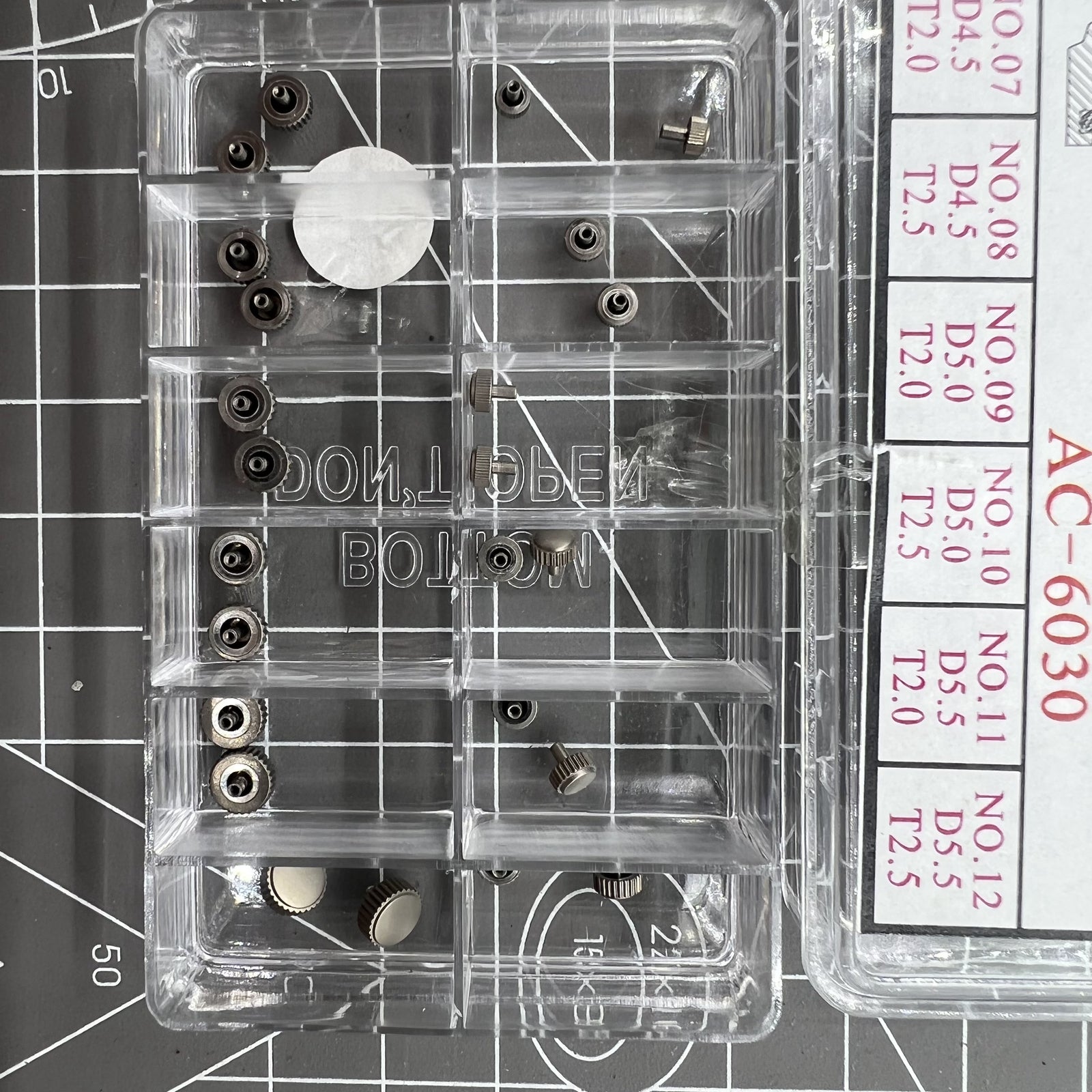 Titanium watch crowns kit, 24 pieces in 12 sizes for precise watch repair.