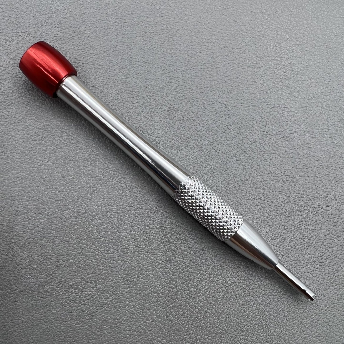 Prong spokes watch screwdriver for precise Richard Mille screw removal and case adjustments.