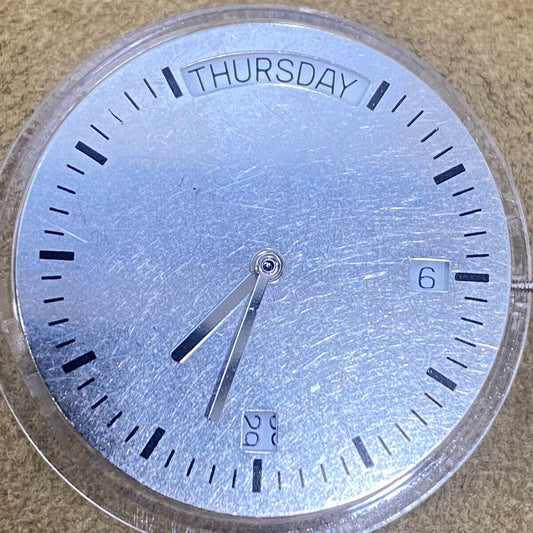 1. China Made 2834-2 automatic mechanical watch movement in silver and gold tones.