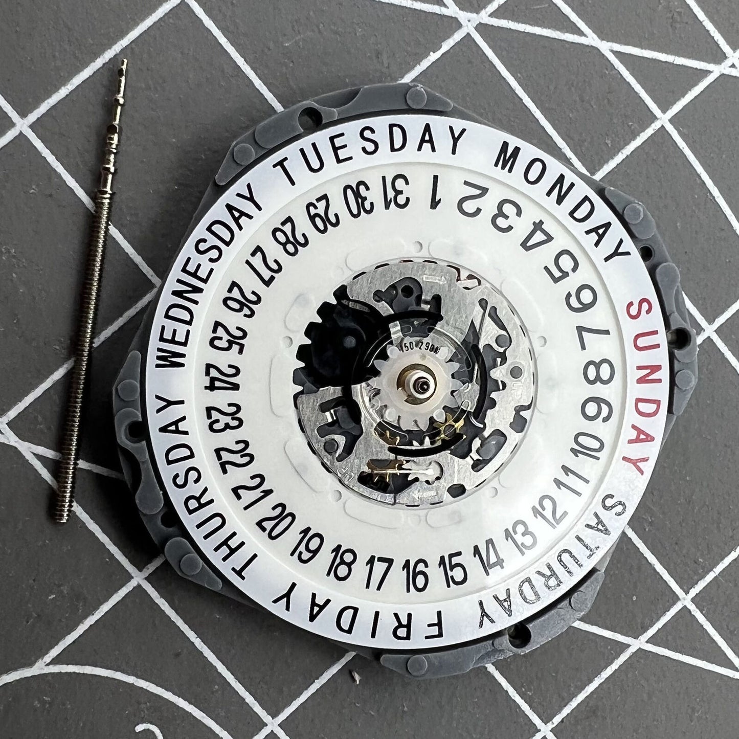 Hattori Epson TMI VJ55 quartz watch movement with date at 6, precision Japan-made component.