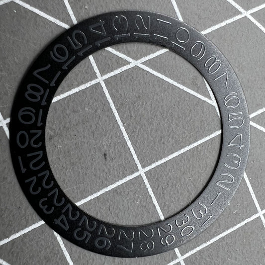 Black background close-up of Grey Character Date Disk for Seiko NH35 NH36 watch movement.