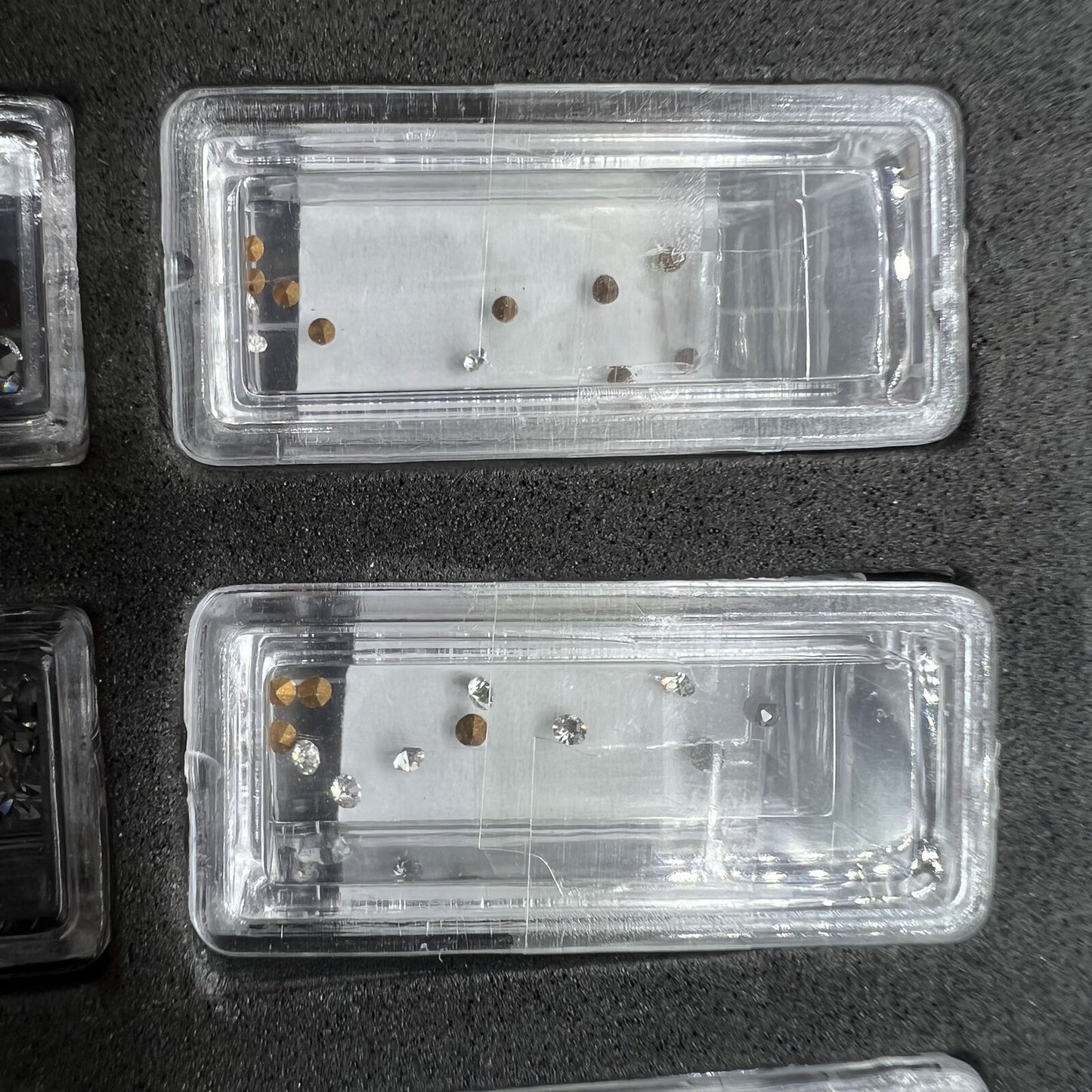 Set of 144 artificial glass stones in 12 sizes for watch dial and case decoration, enhancing style with quality craftsmanship.