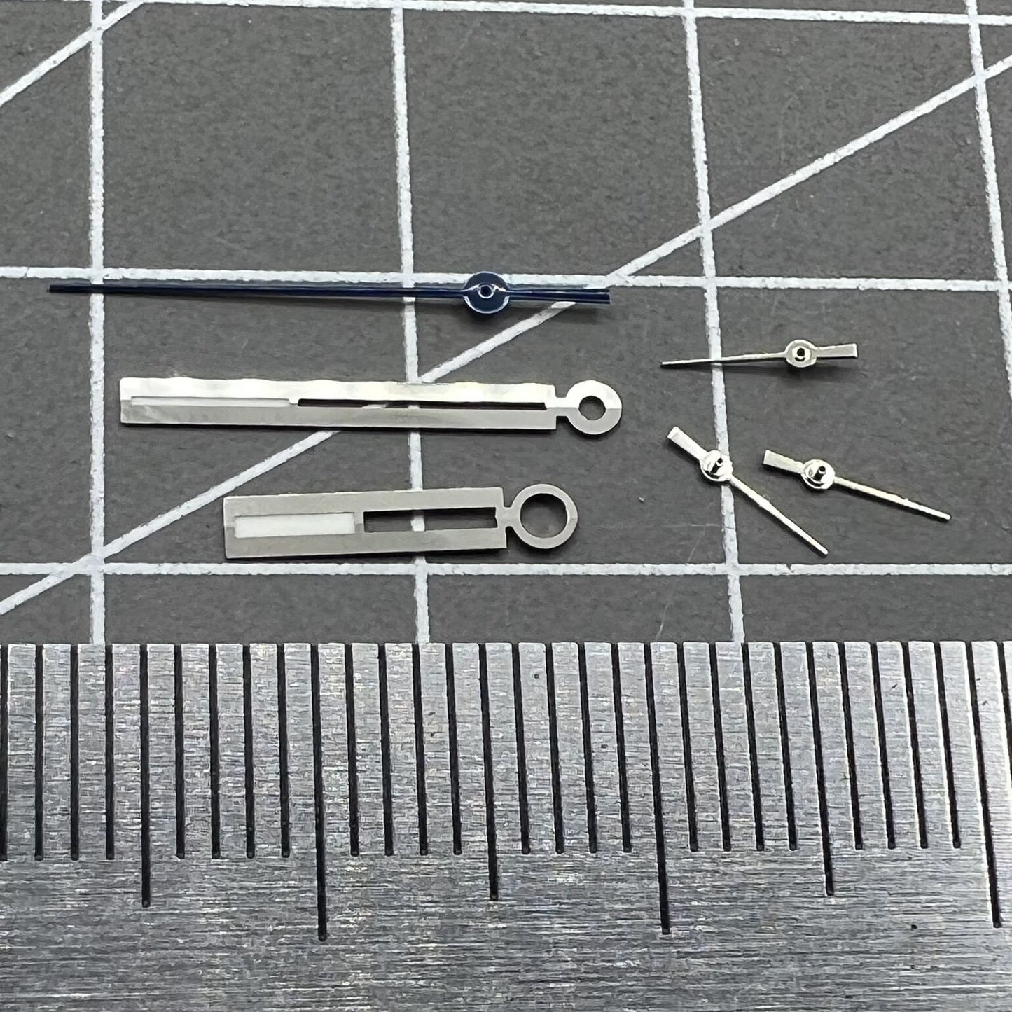 Luminous silver watch hands for Ronda 5021D quartz, perfect for accurate watch repair and upgrades.