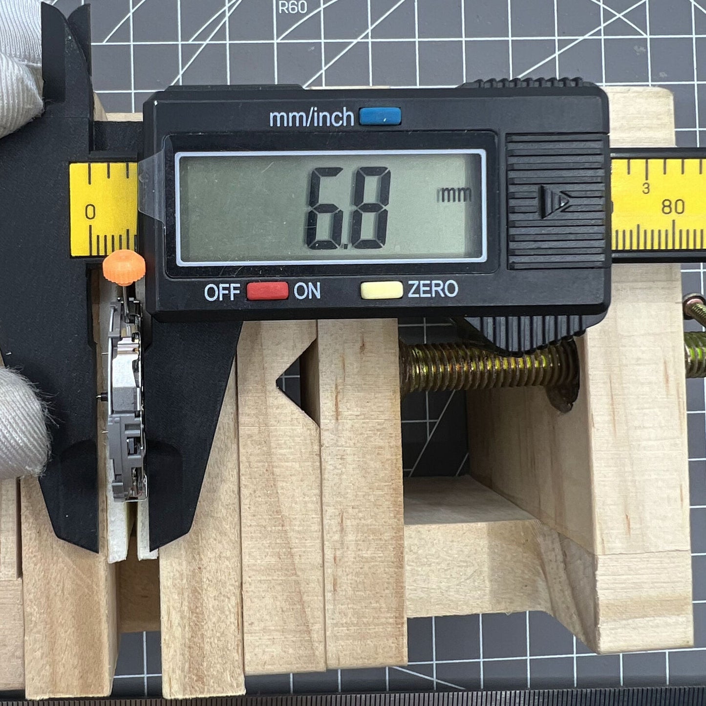 Miyota JS26 quartz watch movement showing small seconds at 3, 6, 9 and date window at 3, Japan made.