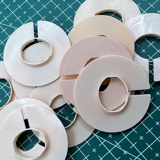 Set of 12 AC-676 5.5 size watch movement spacers, durable casing rings for precise fitting.
