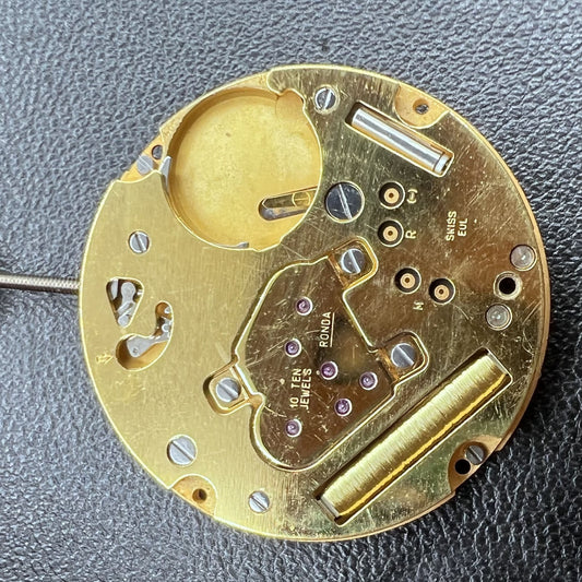 Swiss Ronda 1004 golden watch movement with quartz 2-hand mechanism for precise timekeeping.