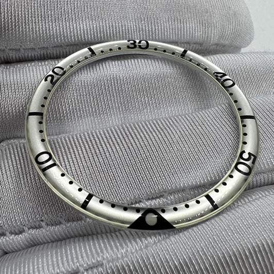 39mm watch bezel with black lume dots on white background, resin and aluminum alloy, watch accessory.