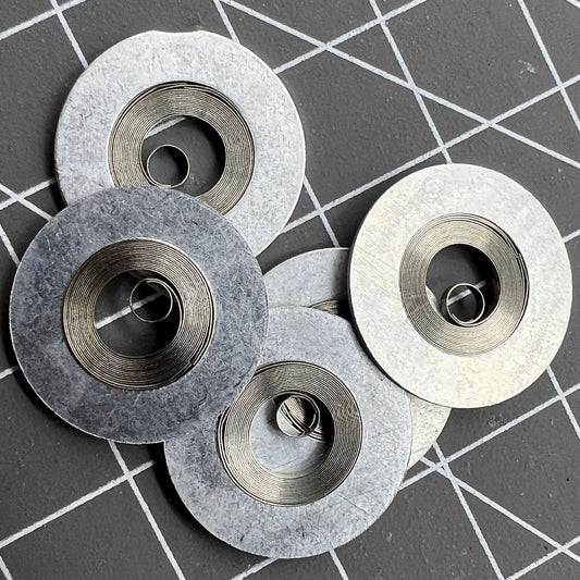 Silver mainspring for movement 7S26#180, compatible with various watch models, durable generic fit.
