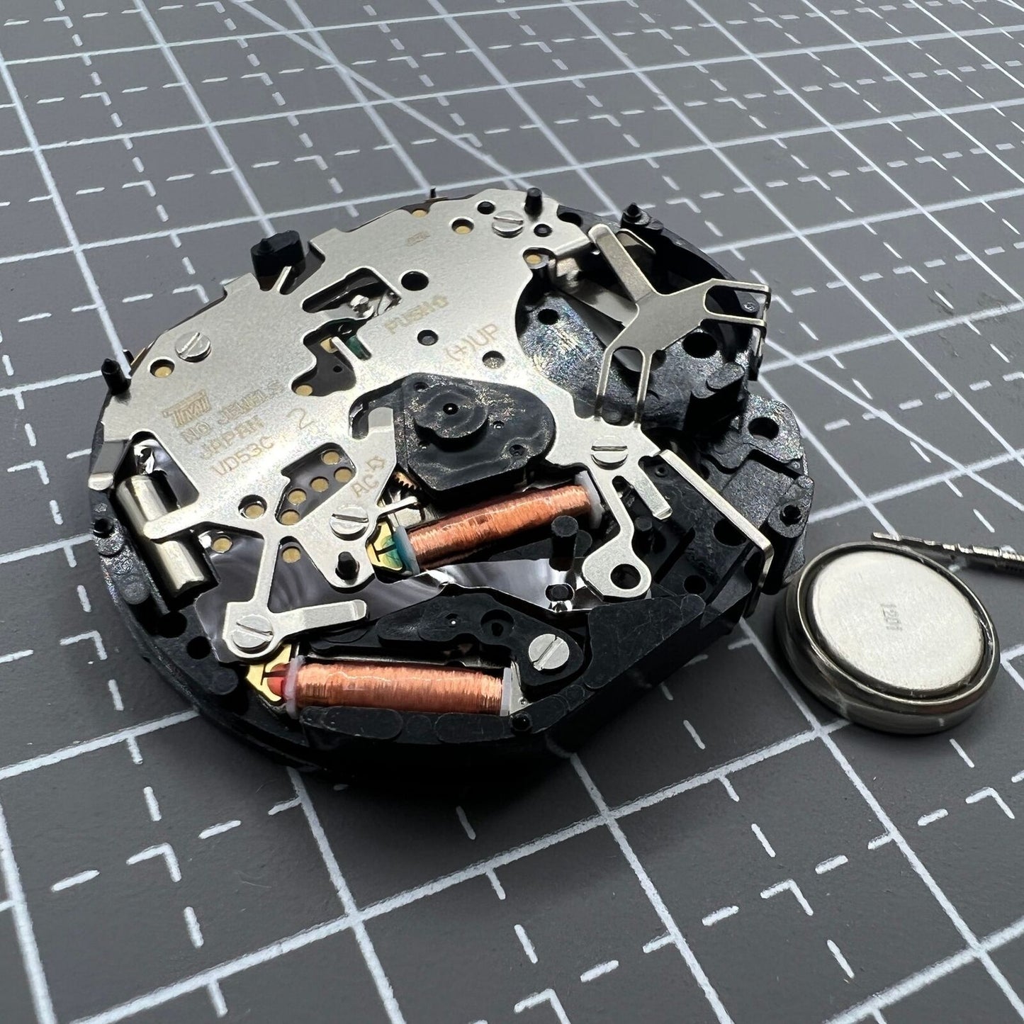 Hattori Epson VD53C quartz watch movement with date display at 6 o'clock, precision Japanese craftsmanship.