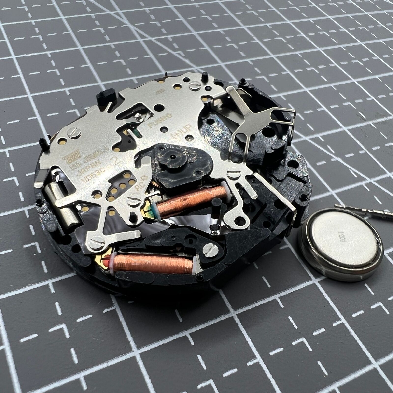 Hattori Epson VD53C quartz watch movement with date display at 6 o'clock, precision Japanese craftsmanship.