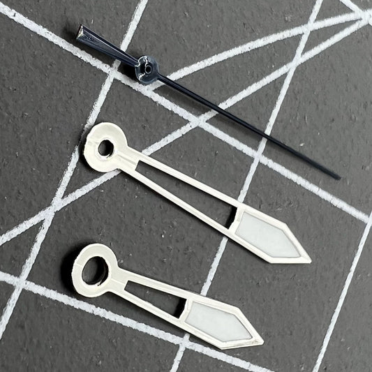 Silver watch hands with dark blue trim and green lume, compatible with Ronda 515 quartz movement, for precise timekeeping.