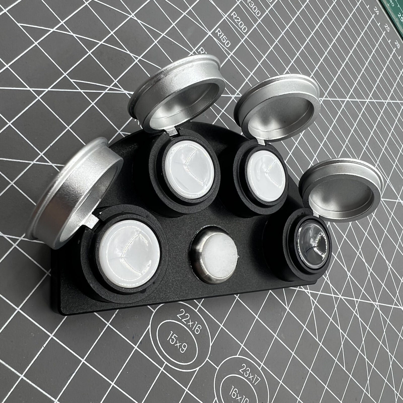 Die-cast alloy oil cup stand with 4 containers and black ceramic inserts for watch maintenance.